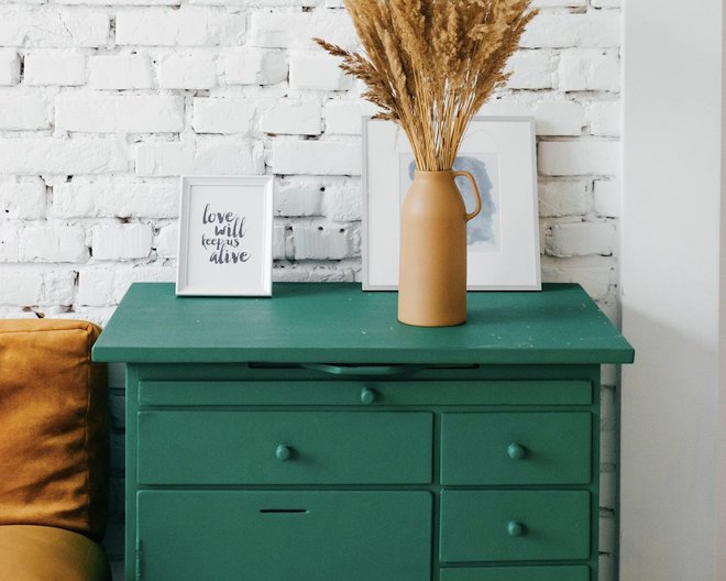 A flower pot on a green drawer